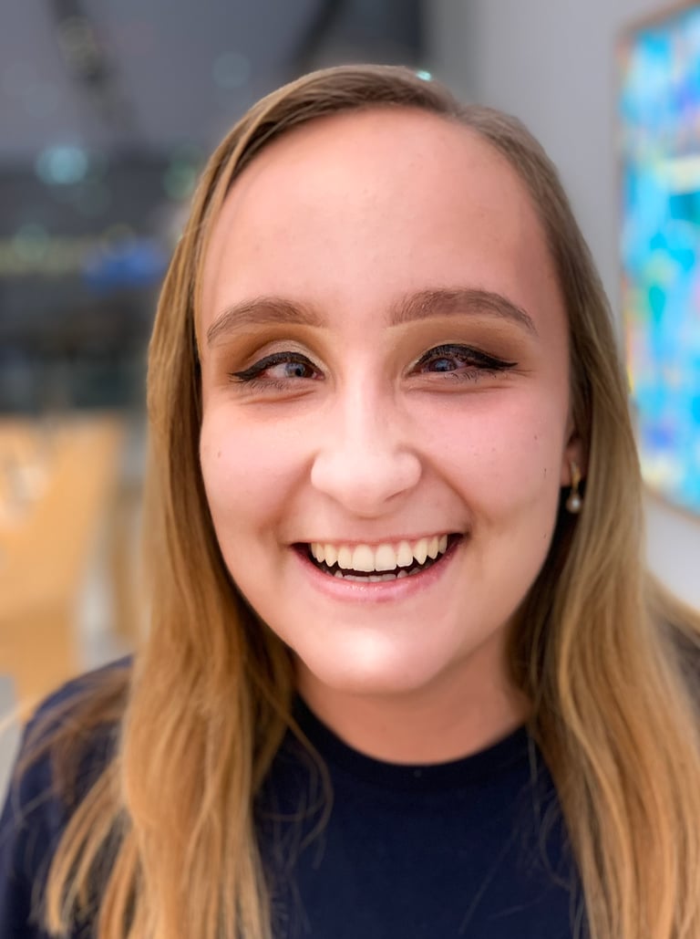 A blond-haired woman founder Zhenya Pankova, smiles at the camera.