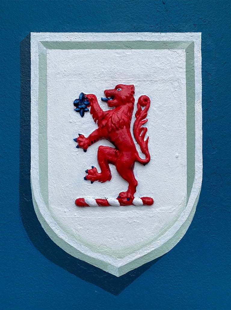 Vibrant lion rampant is surrounded by a crisp white trompe l'oeil shield
