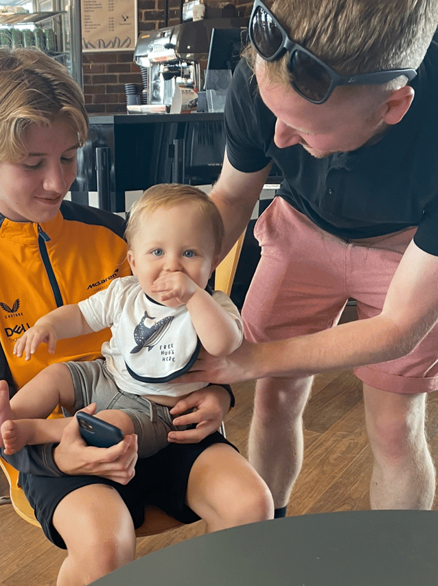 a man and two children sitting in a chair