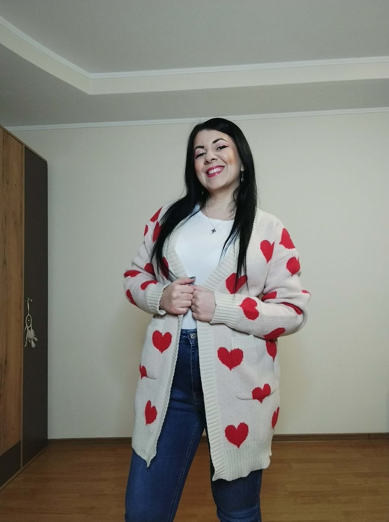 Woman wearing apricot heart print long cardigan sweater with pockets, ribbed knit open front 