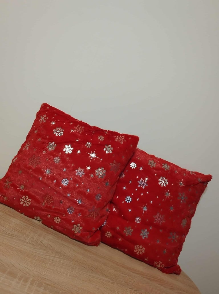 set of 2 red faux fur pillow covers with silver snowflake glitter pattern for Christmas home decor 