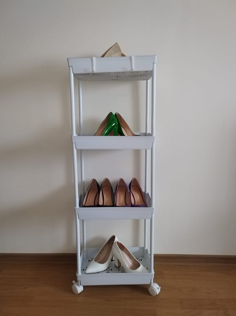 White 4-tier rolling storage cart with wheels and adjustable shelves for organizing kitchen,