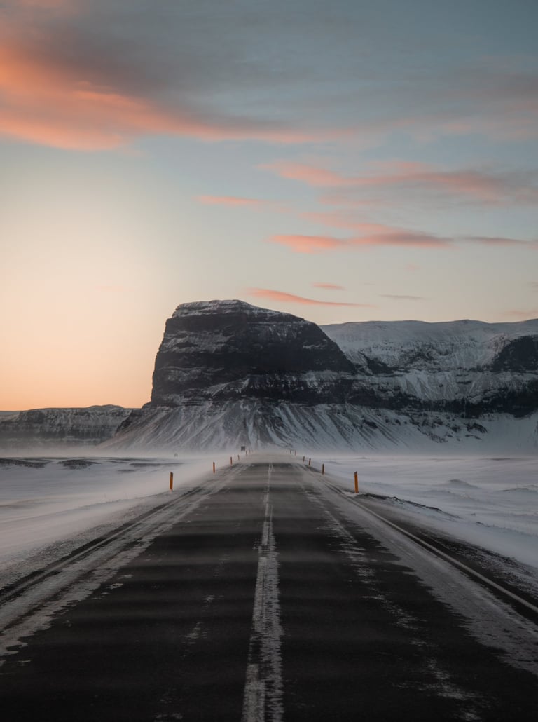 a road with a mountain in the background