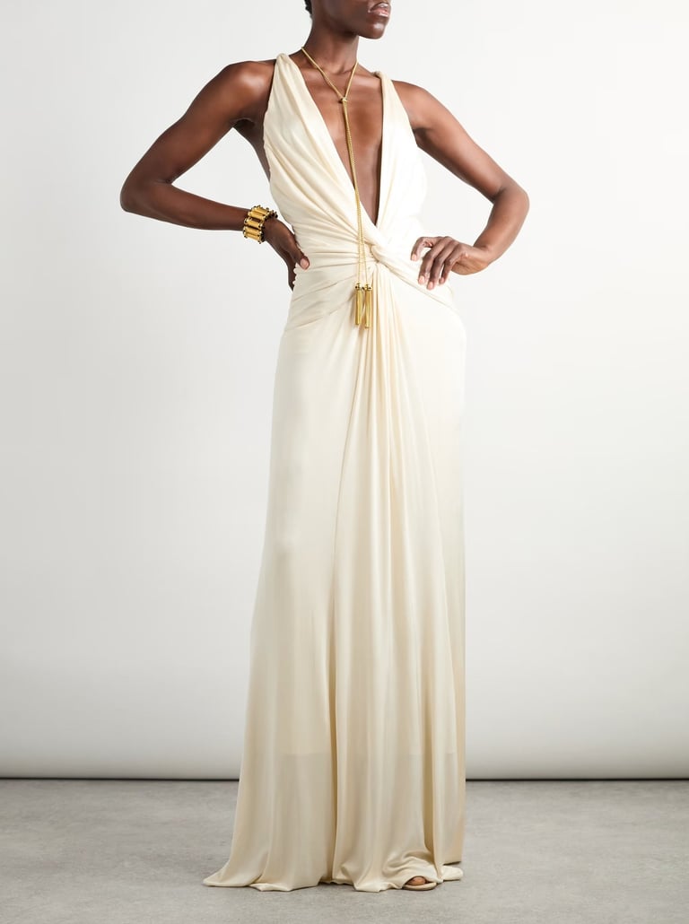 Elegant ivory draped gown with deep plunge neckline – luxury evening wear fashion statement.