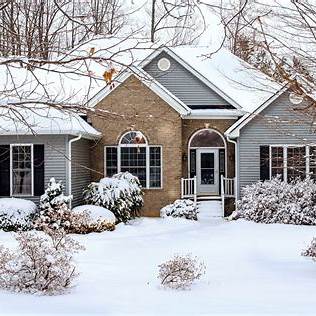 "Snow-covered house exterior in winter, symbolizing seasonal home preparation"