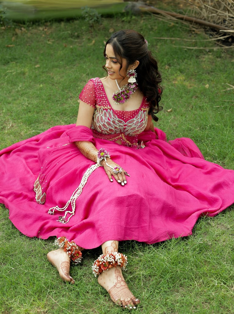 Beautiful haldi bride sitting pose in Vadodara with pink lehenga, bridal makeup and floral jewelry