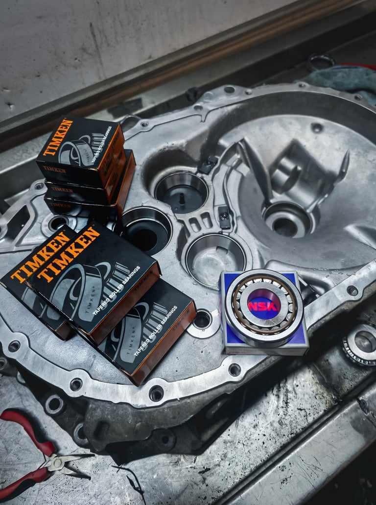New Timken tapered roller bearings and NSK resting on an aluminium transmission housing