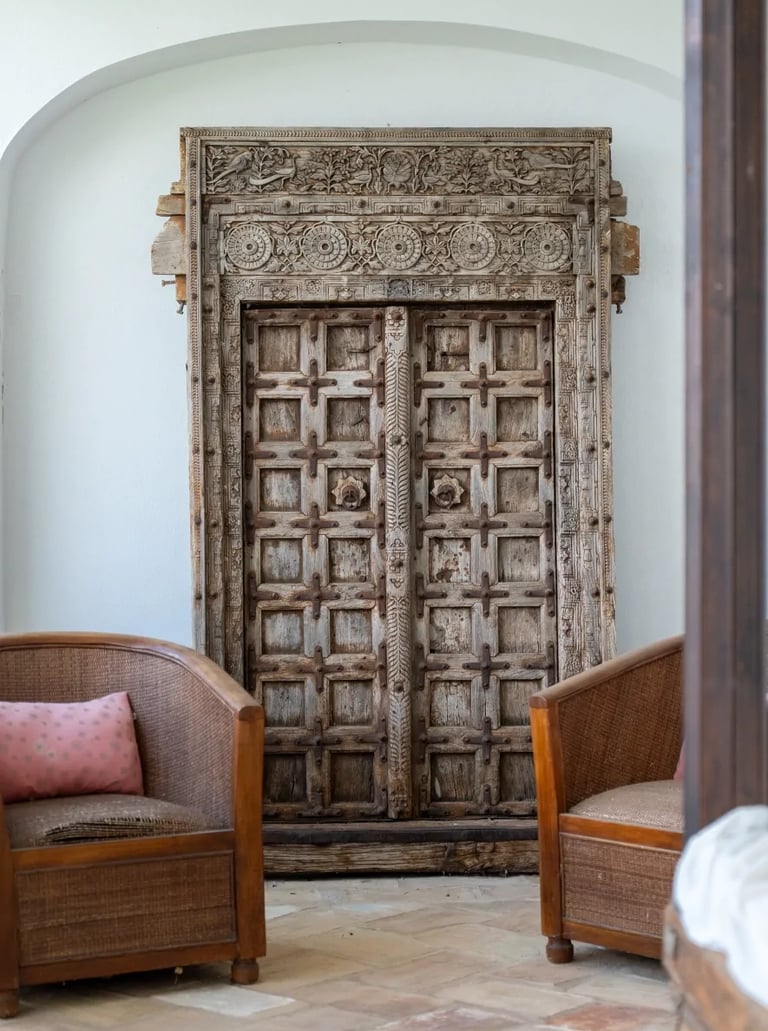 Carved antique wooden door with terracotta flooring