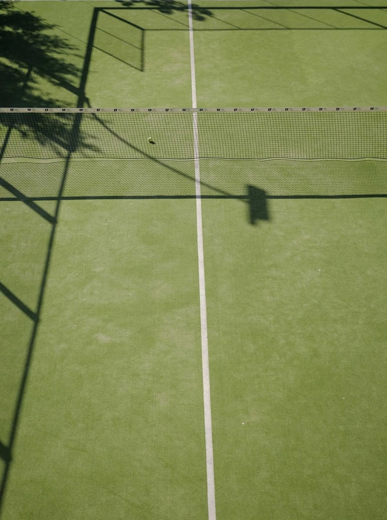 Private padel tennis court with net and green surface