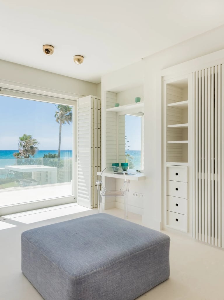 Sea-view bedroom with built-in storage and desk
