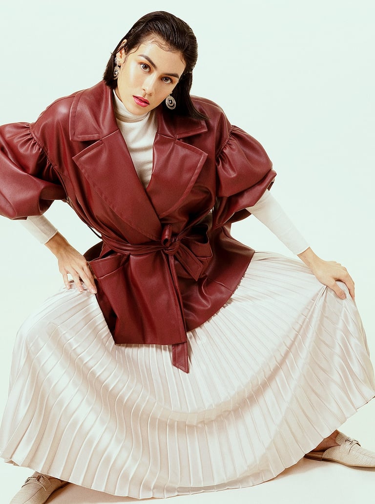modèle femme avec manteau cuir rouge en studio