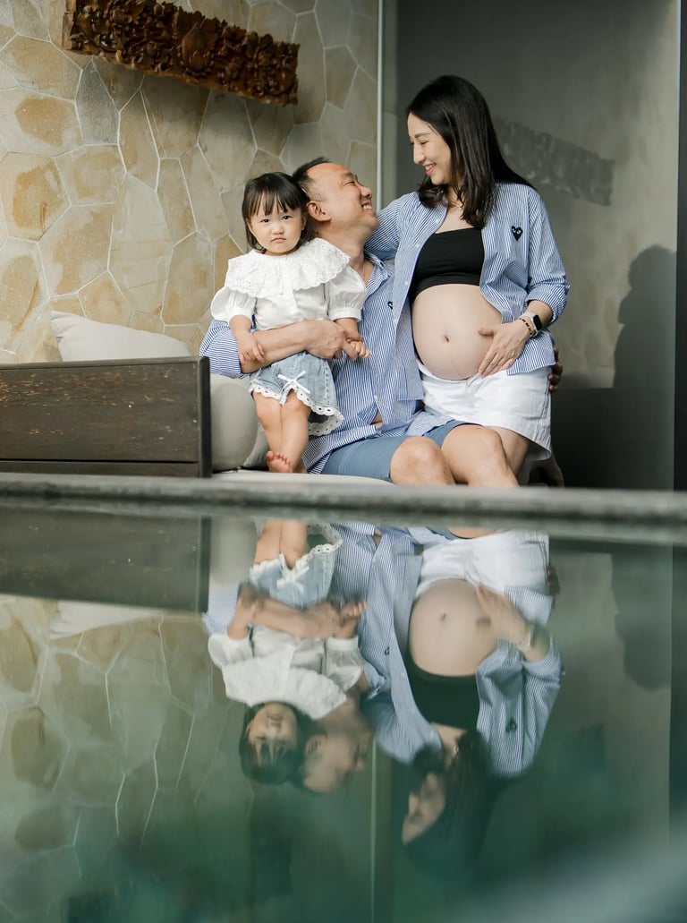 Family babymoon photography with parents and daughter inside a luxury suite at The Apurva Kempinski Bali