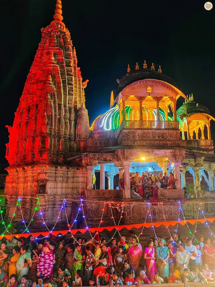 Local women watching Ram Baraat from a temple silhouette at Kota Dussehra Mela.