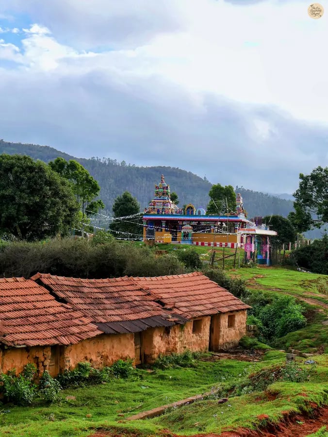 Small serene temple surrounded by greenery in Poondi village, Kodaikanal.