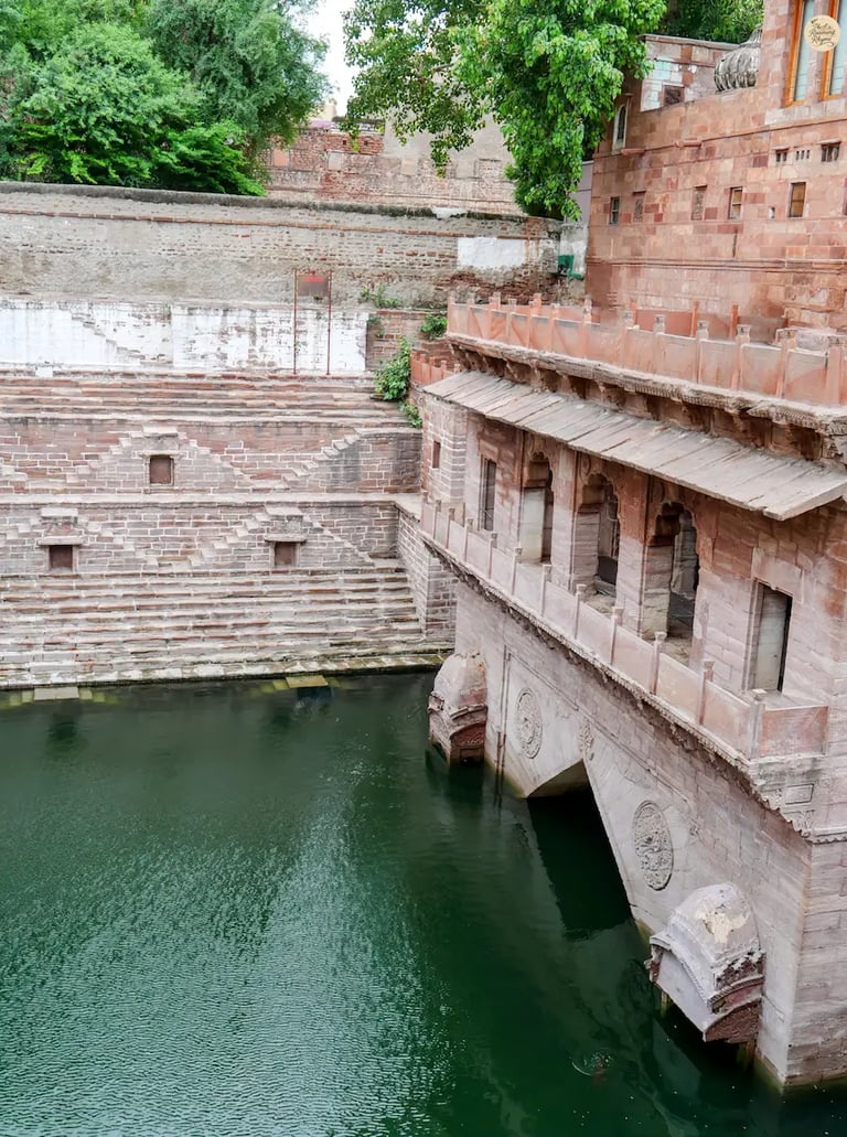 Historic Toorji ka Jhalra stepwell in the Blue City of Jodhpur, showcasing layered steps and deep water.