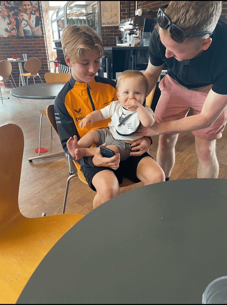 a man and two children sitting in a chair