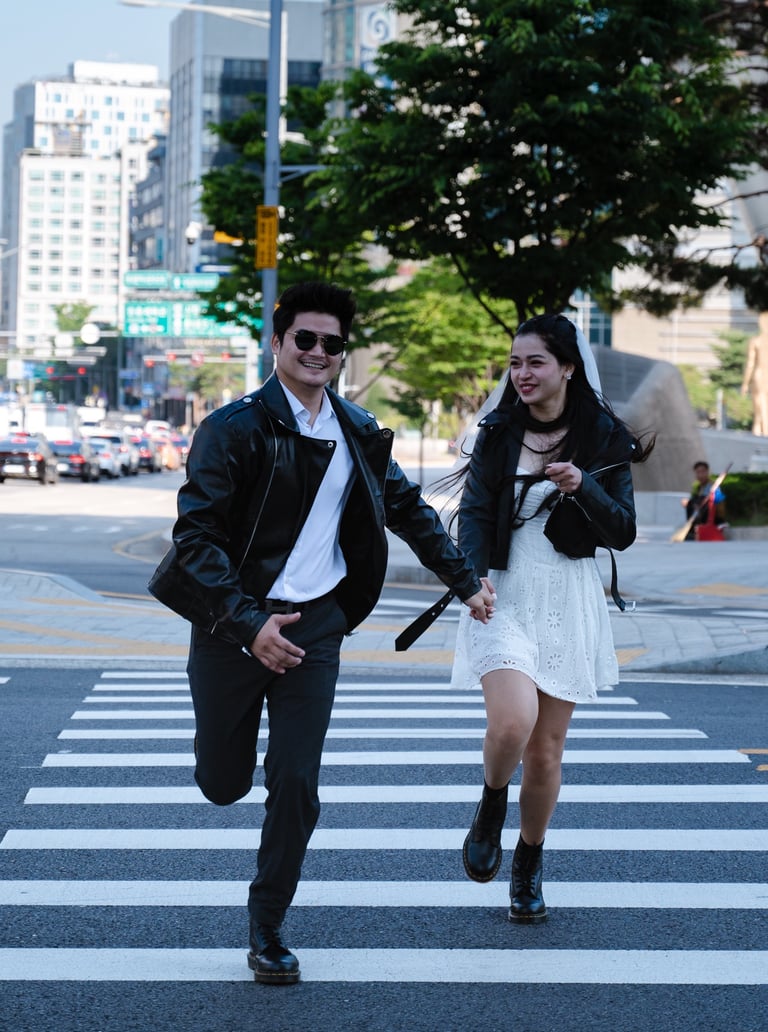 prewedding couple walking across a crosswalk