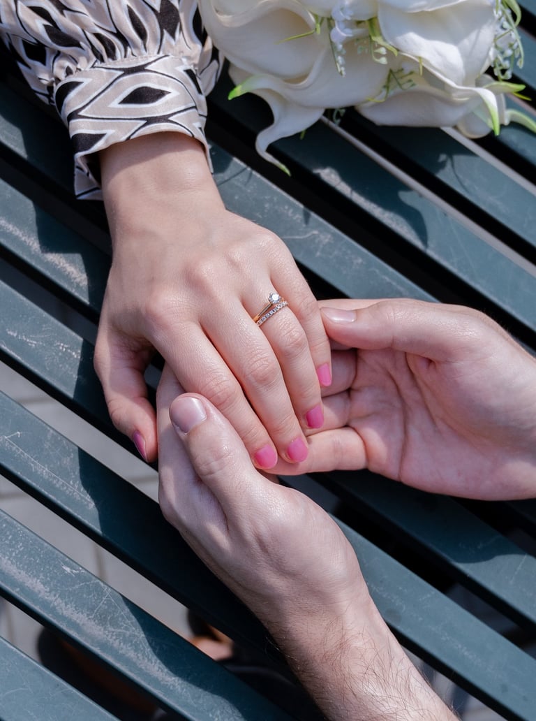a man and woman holding hands on a table