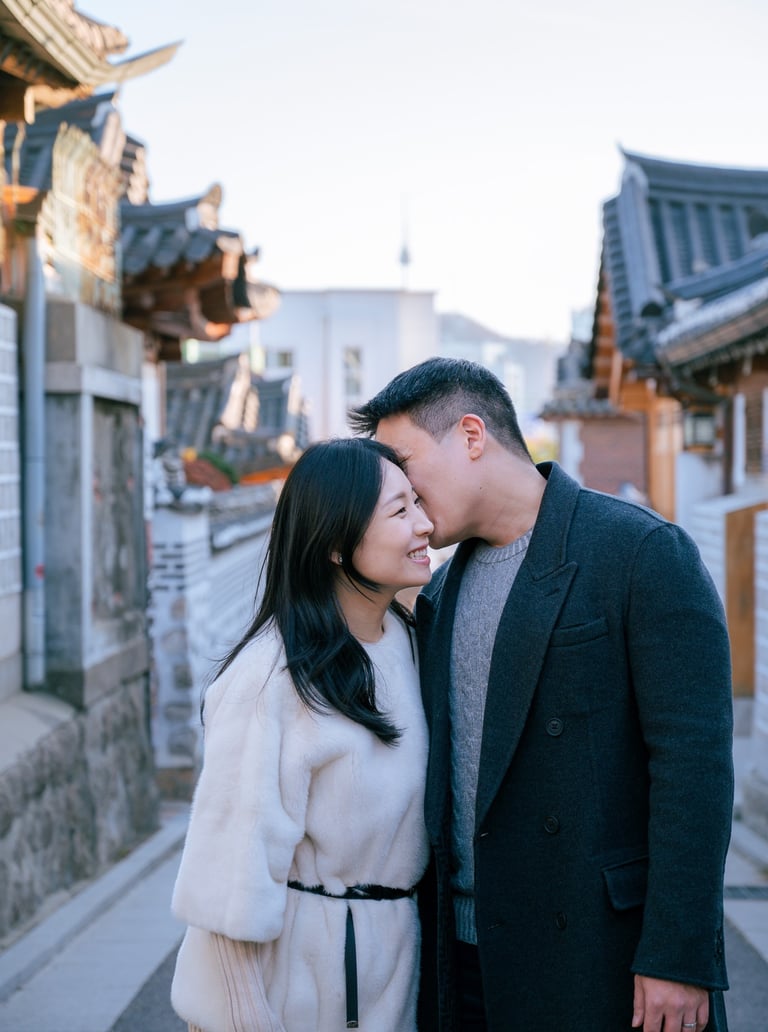 a man and woman standing in Hanok Village