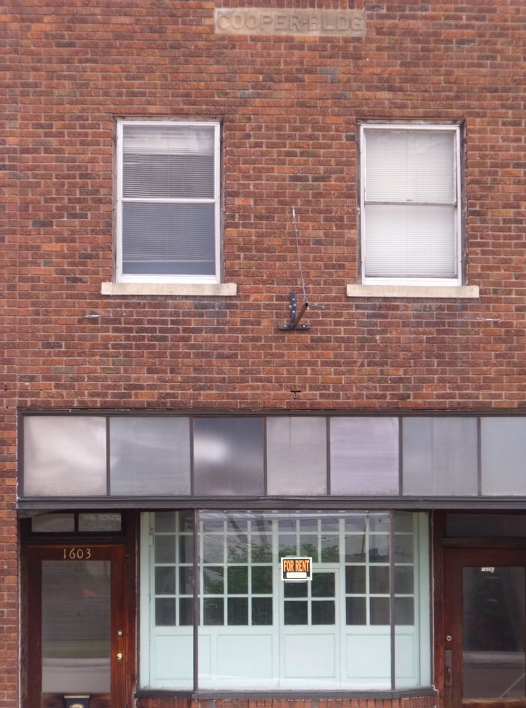A for rent sign hangs in an empty business in a small town in Nebraska