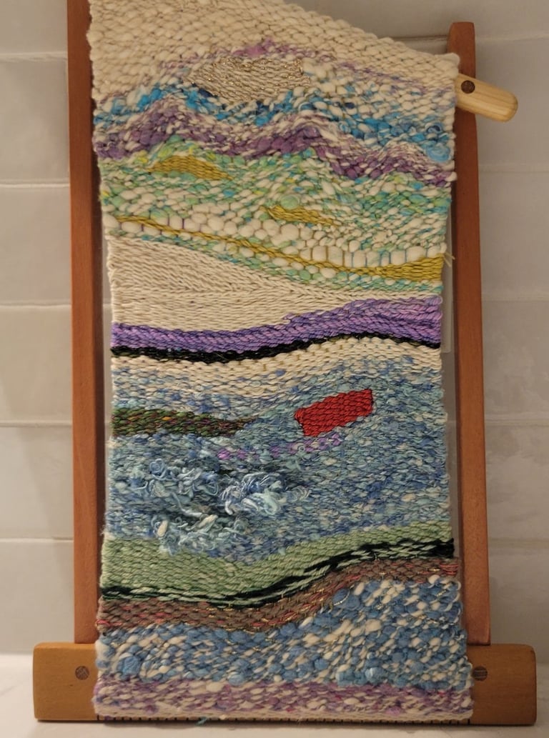 Hand-woven abstract tapestry on a frame.
