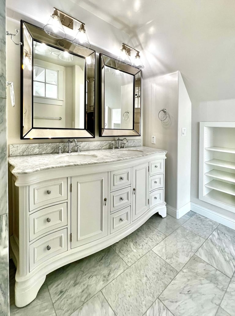 Bathroom with traditional architectural style, beautiful radius wood vanity, and marble countertops.
