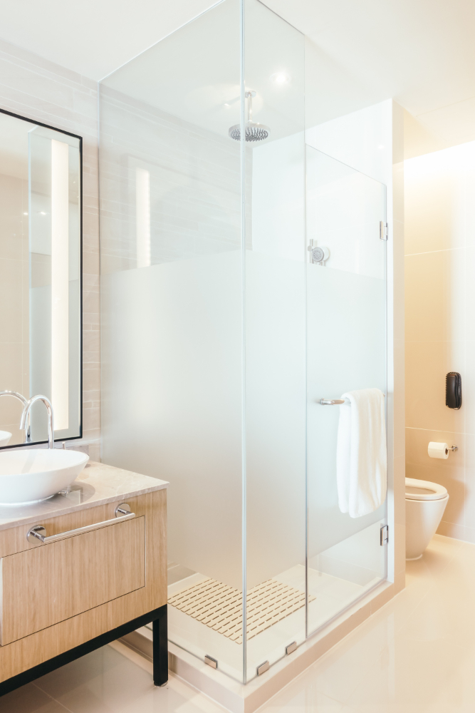Contemporary bathroom with frosted glass shower and wooden vanity – finished look after a cracked tr