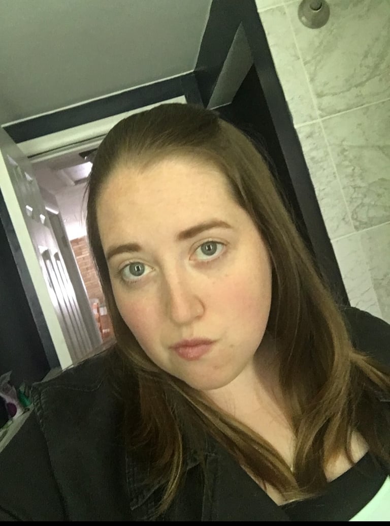 a woman with a blue eyes, black jacket and shirt