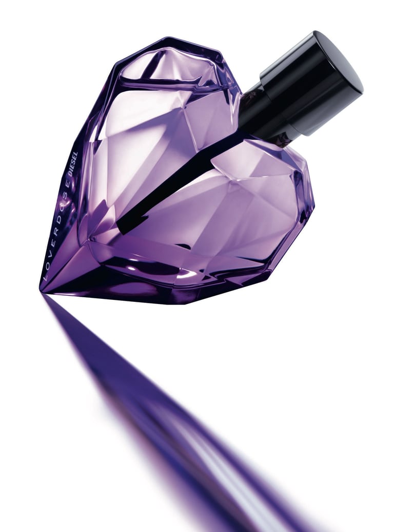 a purple perfume bottle with a diamond shaped diamond