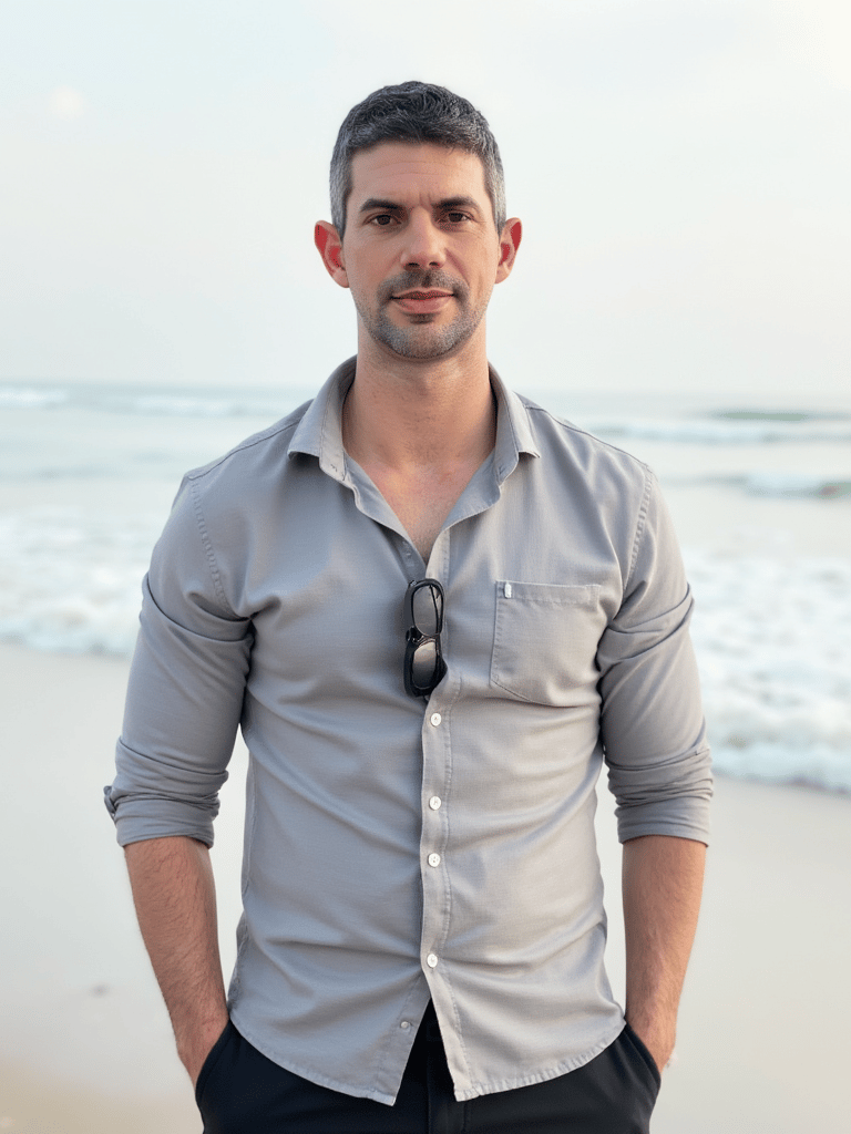 Adam Bair, wellness advocate and Miami resident, standing on the beach in South Florida