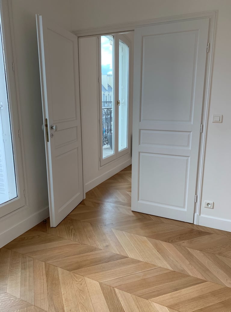 a room with a door and a door way to a balcony