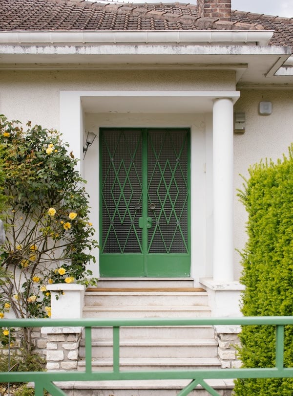 a green door with a green gate and a green gate