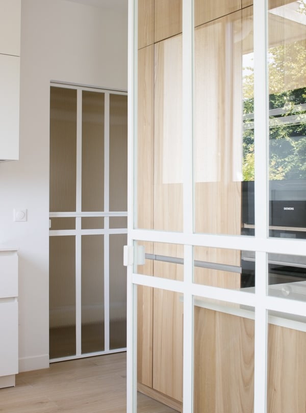 a kitchen with a wooden floor and a white cabinet