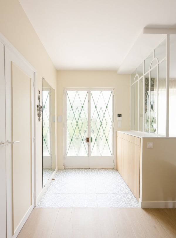 a hallway with a large window and a door