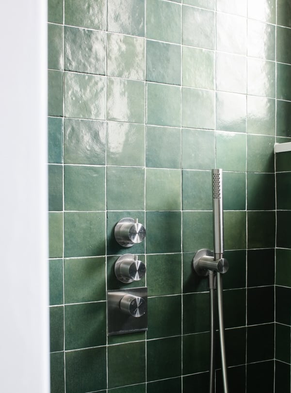 a shower with a shower head and a shower head
