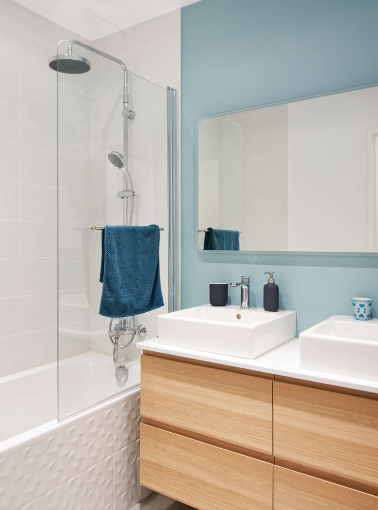 a bathroom with a blue wall and a white sink