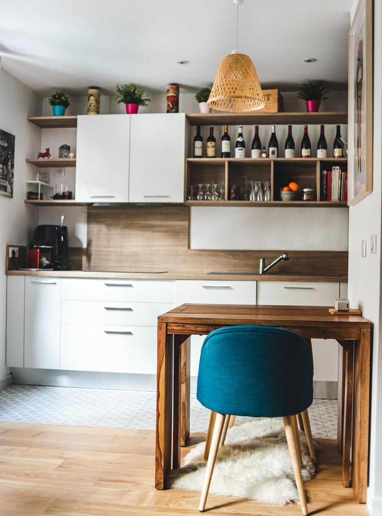 a kitchen with a table and chairs in the middle of the room