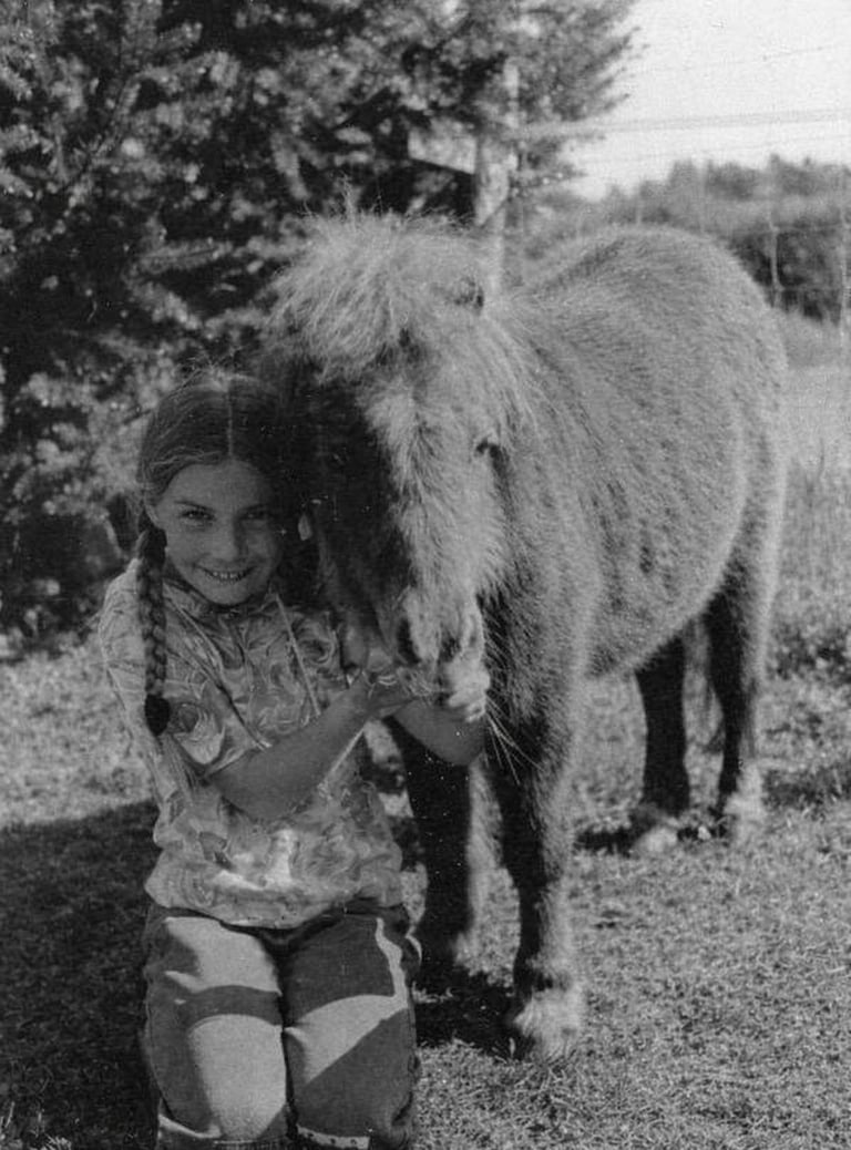Kindheitsbild der Ponytante wie sie ein Ponyfohlen kuschelt