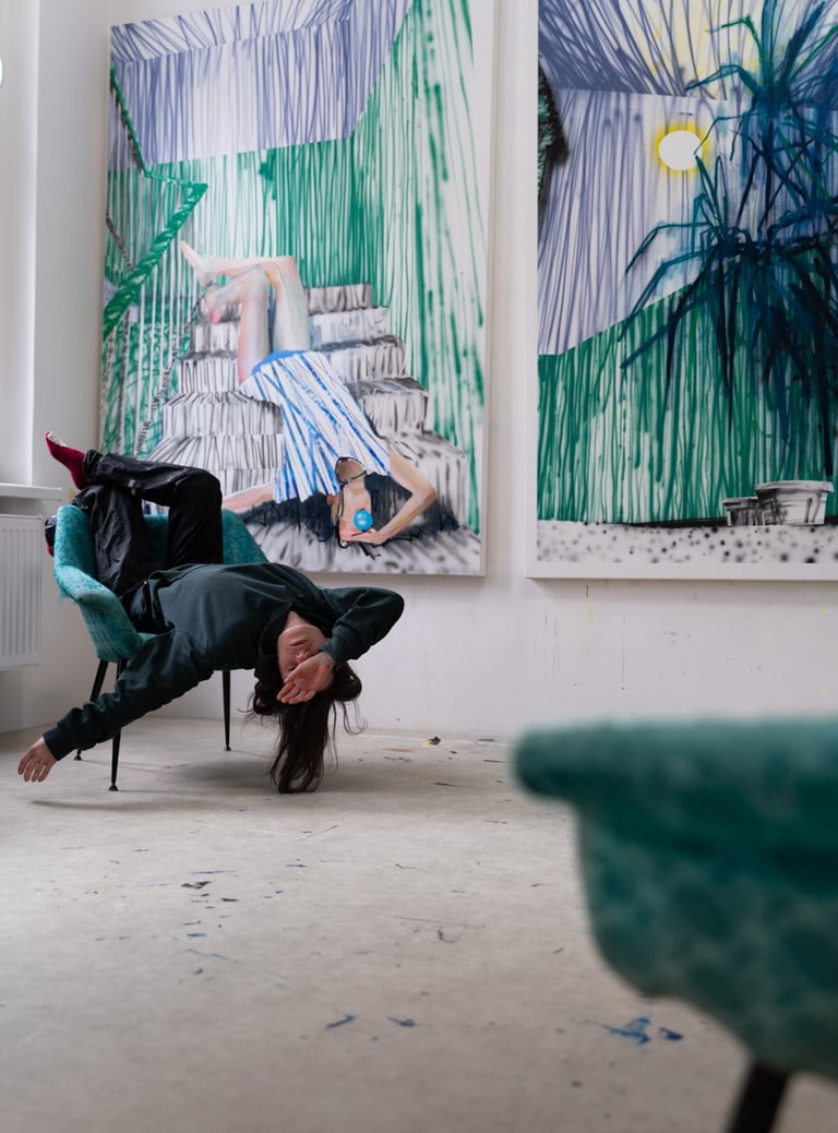 Hadas Patryk, model posing upside down in a studio with large abstract contemporary paintings.
