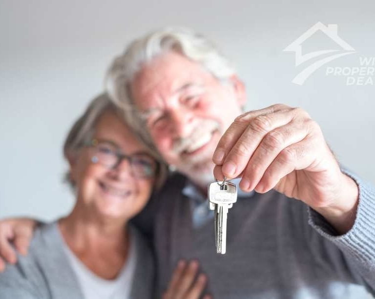 happy older couple keys in hand
