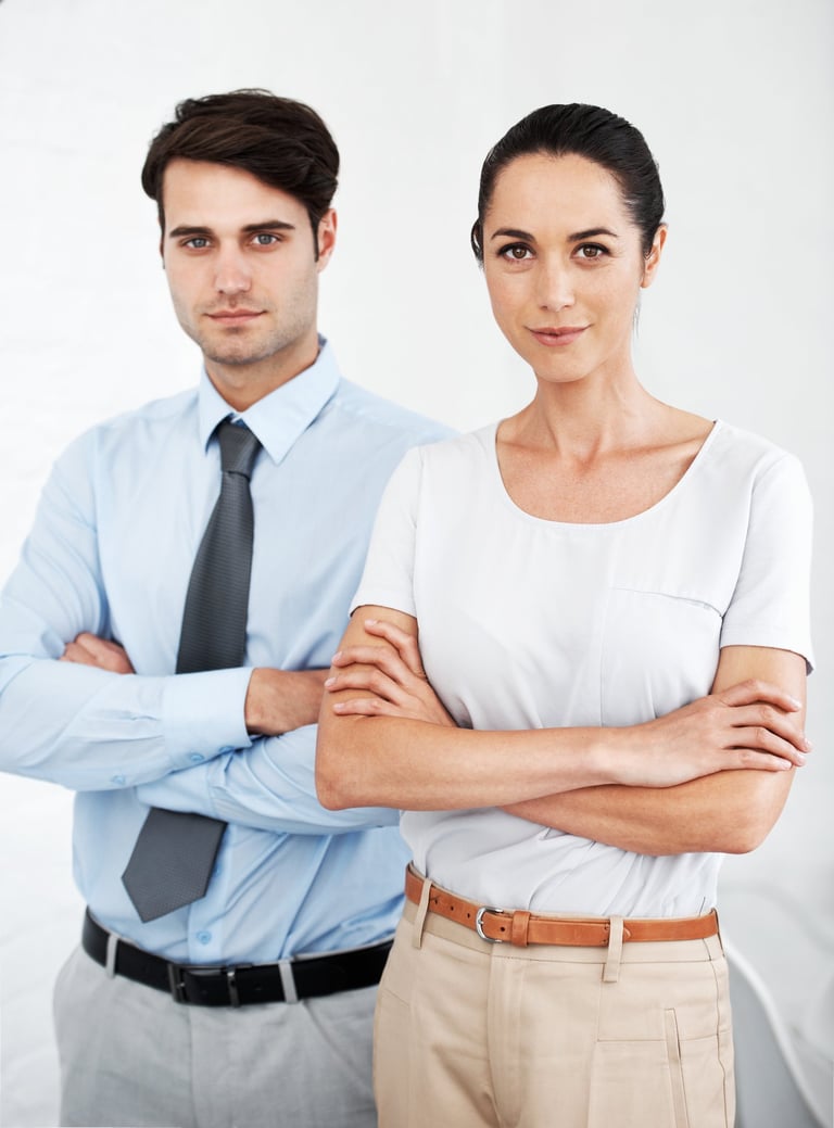 a man and woman standing in front of a white wall