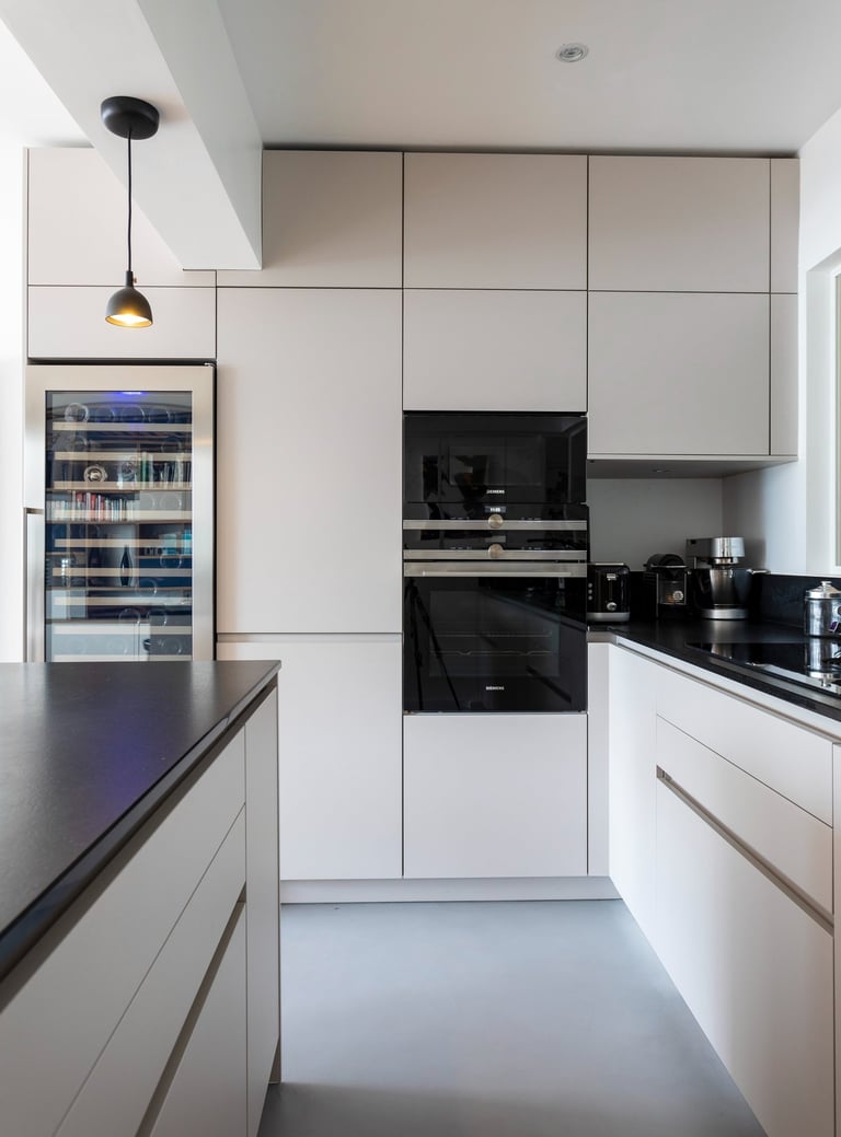 a kitchen with a refrigerator and a refrigerator freezer