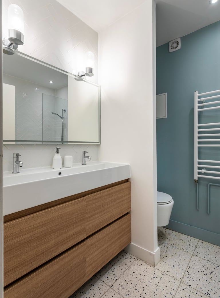 a bathroom with a white toilet and a sink