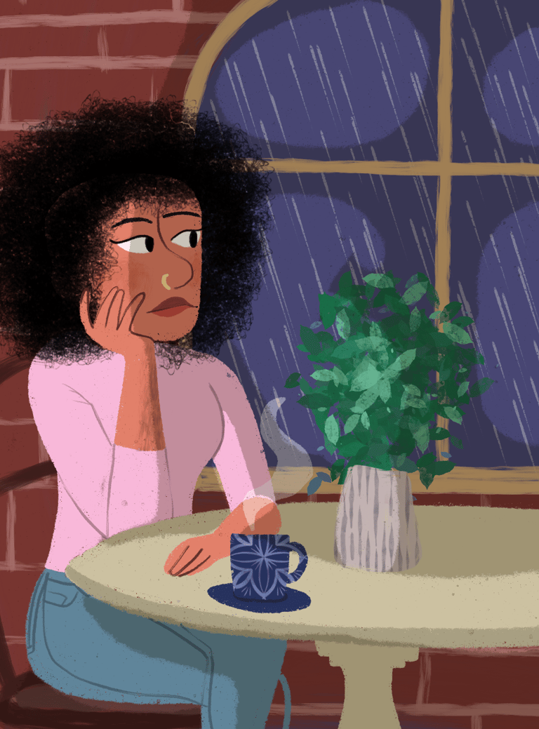 a woman sitting at a table with a cup of coffee. Diane Mulolo Faida