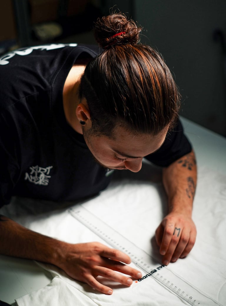 a man is looking down at a white sheet of paper