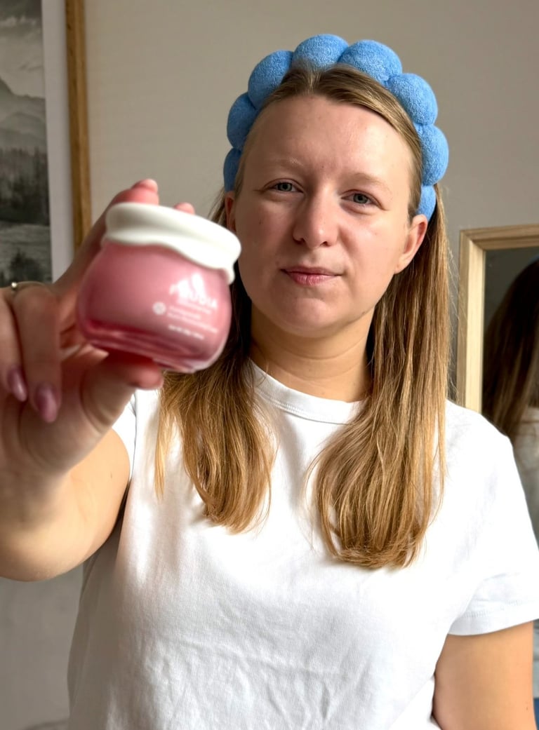 a woman in a white shirt  holding a jar of cream UGC