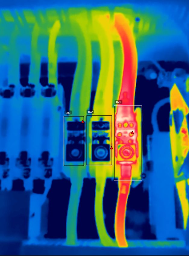 Thermal imaging scan of electrical wires showing a hot circuit breaker hotspot.