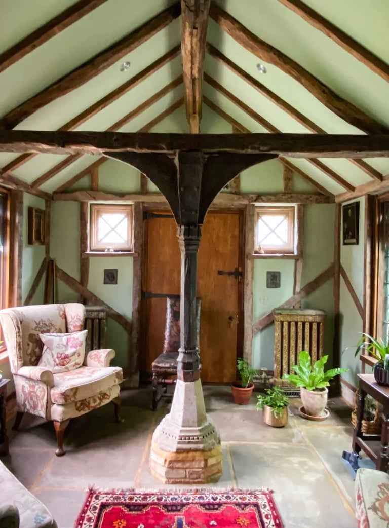 Interior design of an antique room with plaster walls, wooden beams and antique furniture 