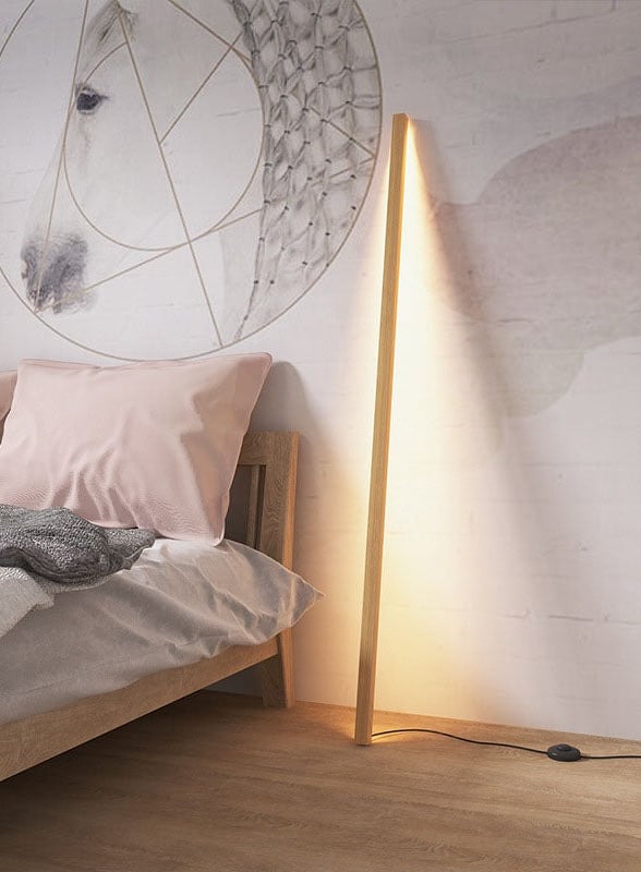 a bed with a lamp and a lamp on the side of the bed