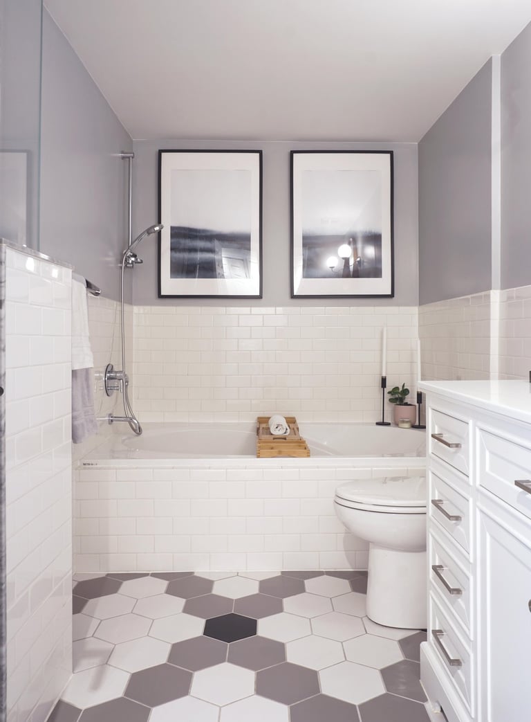 a bathroom with a white toilet and a hex pattern floor